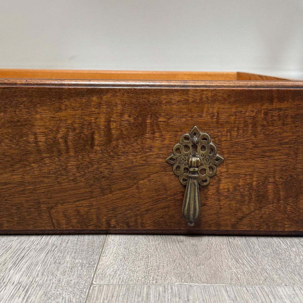 An Edwardian mahogany writing table featuring four drawers with ornamental brass drop handles, a central kneehole aperture, and four cabriole legs. View XI
