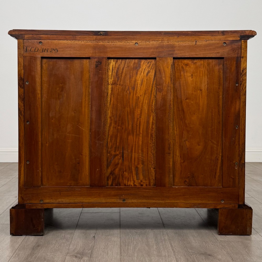 A 20th-century Georgian style mahogany chest featuring four full-width drawers with brass drop handles, flanked by ebonised side columns, resting on bracket feet. View V