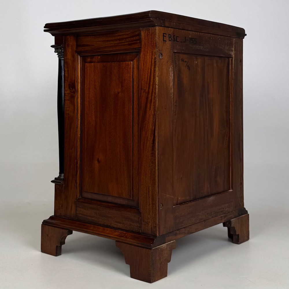 A pair of matching mahogany bedside cabinets with single top drawers, panelled cupboard doors, and black ebonised side columns. View VI