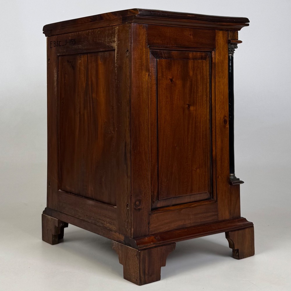 A pair of matching mahogany bedside cabinets with single top drawers, panelled cupboard doors, and black ebonised side columns. View VIII