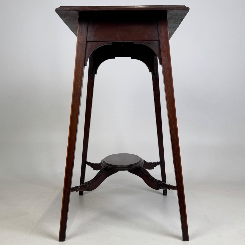 An Edwardian mahogany side table featuring a square top, splayed legs, corner spandrels, and a central circular undertier supported by shaped stretchers. View III