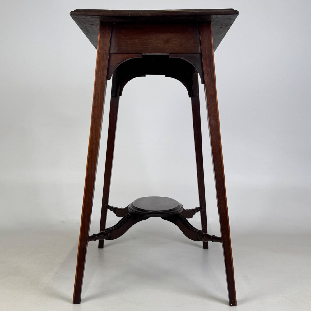 An Edwardian mahogany side table featuring a square top, splayed legs, corner spandrels, and a central circular undertier supported by shaped stretchers. View VII