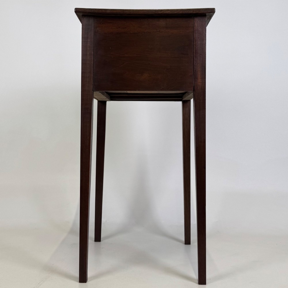 An antique dark mahogany side table featuring two stacked drawers with circular handles, supported by tall tapered square legs. View VII