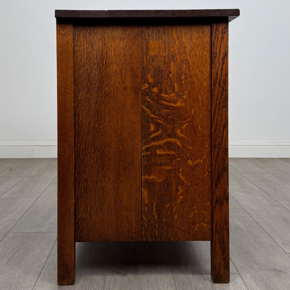 An antique Arts and Crafts oak chest of drawers featuring two short drawers over two full-width drawers with iron drop-ring handles on square backplates. View VII