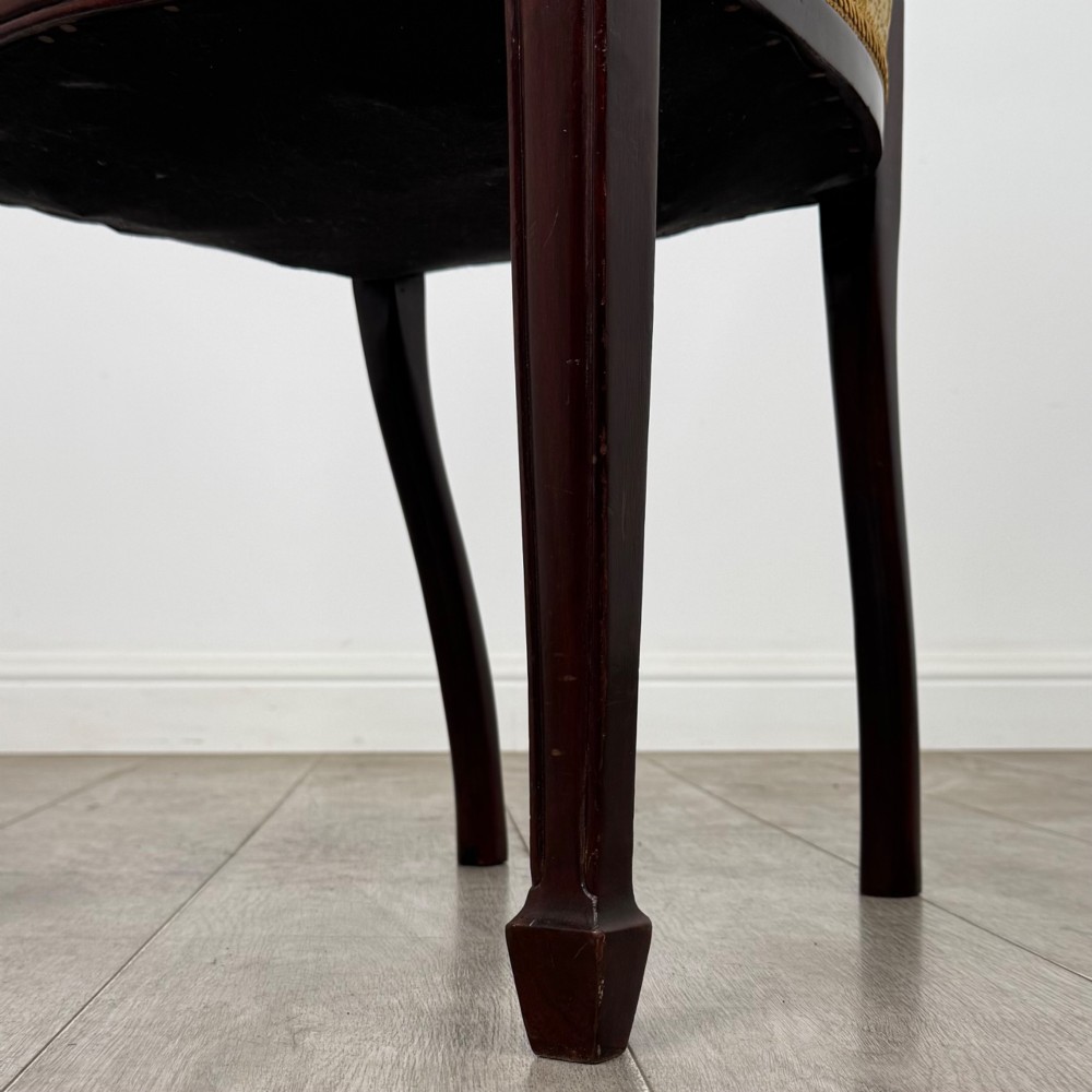 A set of four dark mahogany dining chairs with carved oval backs, slender vertical splats, and gold damask upholstered seats. View VI
