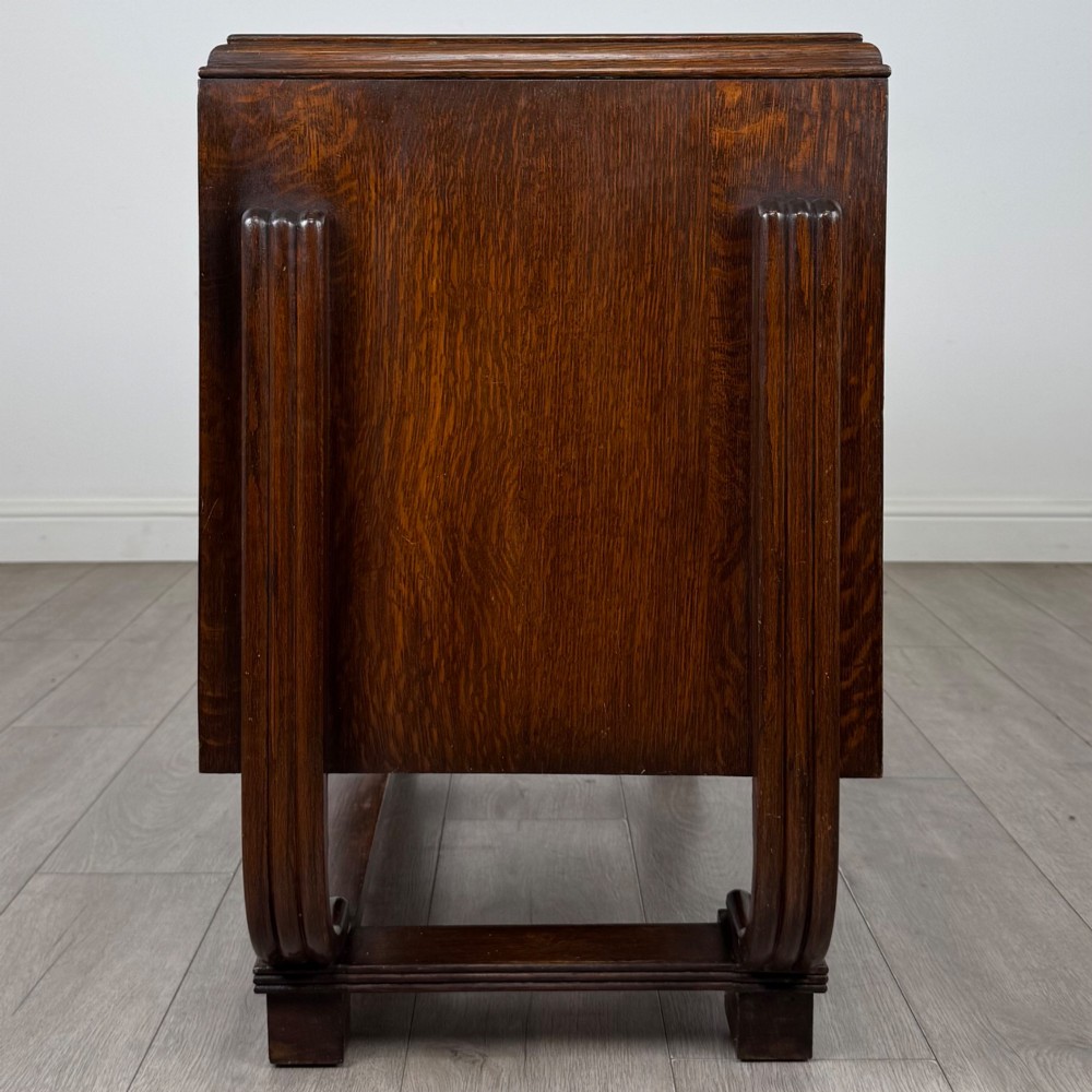 An Art Deco oak desk featuring two side cupboard pedestals supported by u-shaped curved legs and a central drawer. View VIII