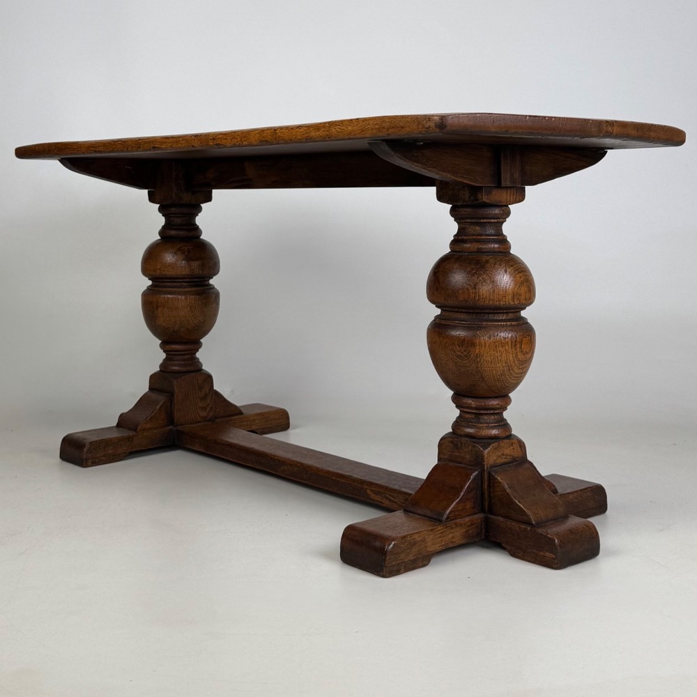 A small 20th-century solid oak coffee table featuring heavy bulbous turned baluster legs connected by a low stretcher base. View II