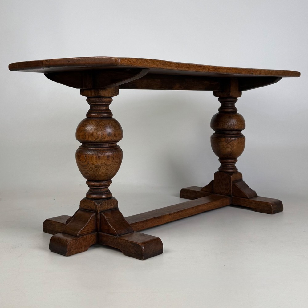 A small 20th-century solid oak coffee table featuring heavy bulbous turned baluster legs connected by a low stretcher base. View IV