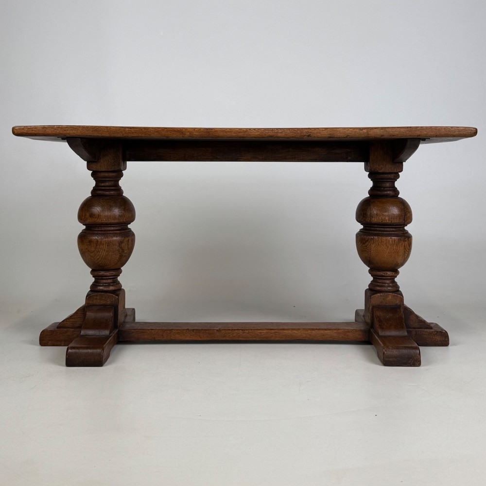 A small 20th-century solid oak coffee table featuring heavy bulbous turned baluster legs connected by a low stretcher base. View V