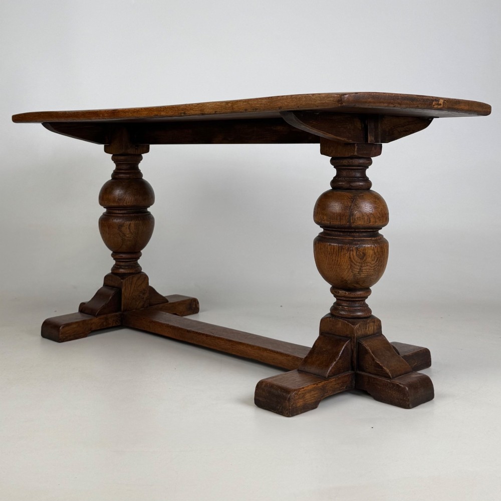 A small 20th-century solid oak coffee table featuring heavy bulbous turned baluster legs connected by a low stretcher base. View VI