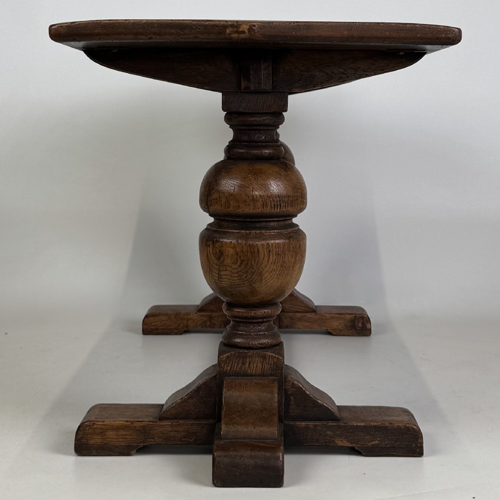 A small 20th-century solid oak coffee table featuring heavy bulbous turned baluster legs connected by a low stretcher base. View VII