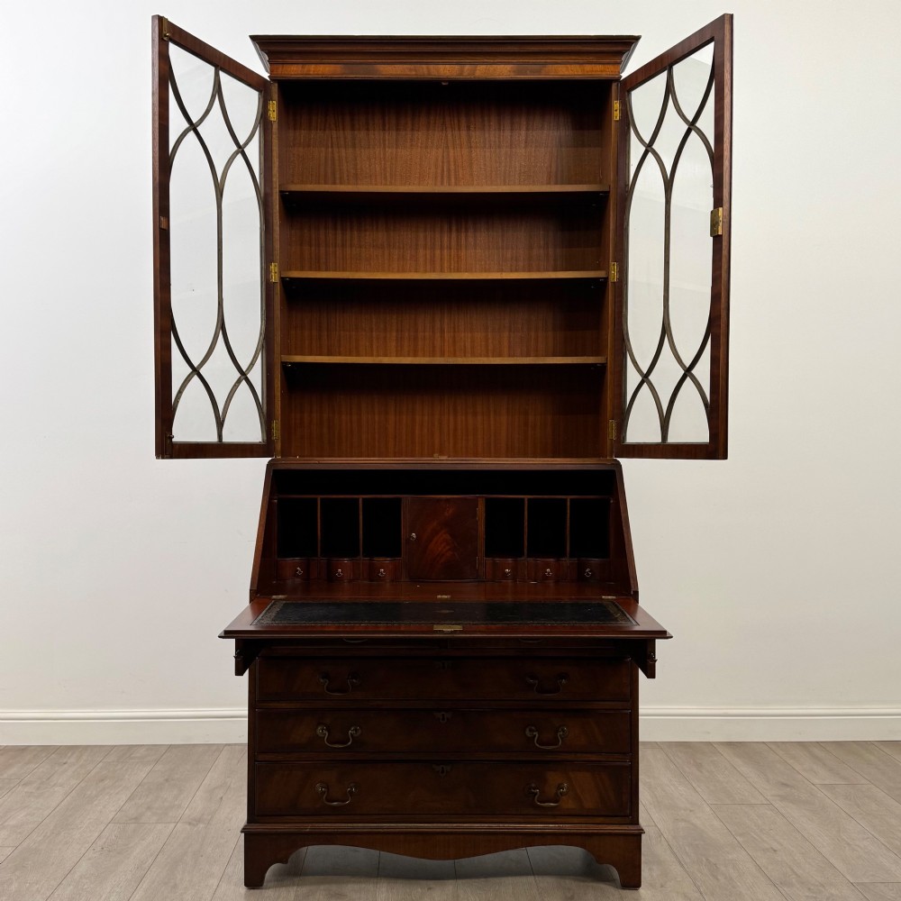 An antique mahogany bureau bookcase featuring two astragal glazed glass upper doors above a lower drop-front writing slope and four drawers. View III