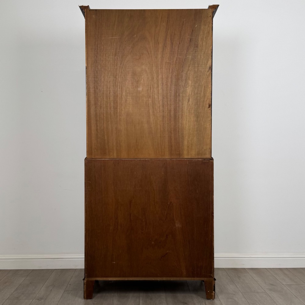 An antique mahogany bureau bookcase featuring two astragal glazed glass upper doors above a lower drop-front writing slope and four drawers. View VII