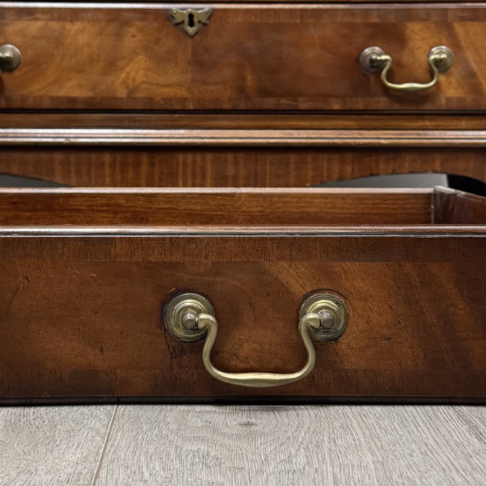 An antique mahogany bureau bookcase featuring two astragal glazed glass upper doors above a lower drop-front writing slope and four drawers. View XIV