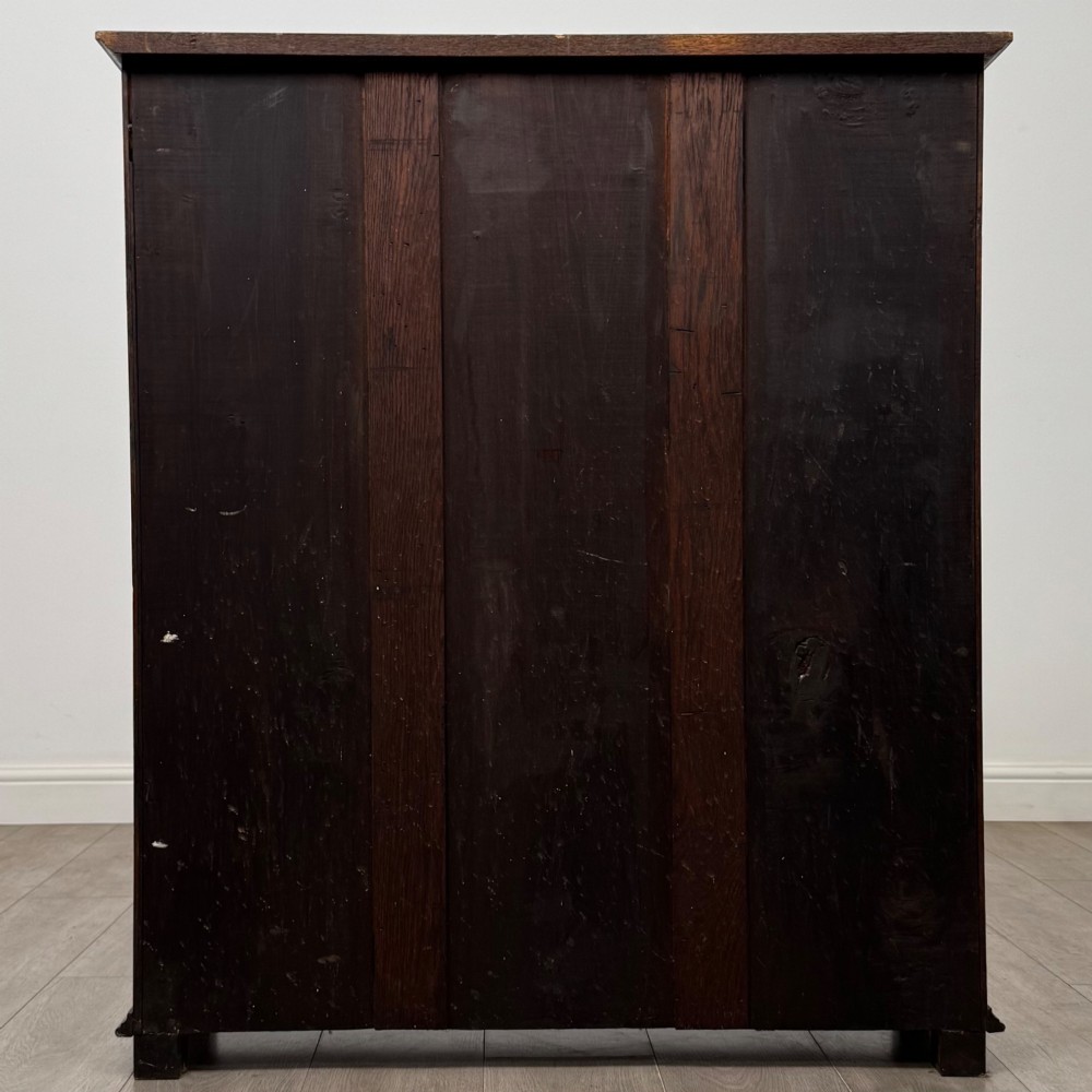 An Edwardian open oak bookcase with four wide shelves and dark timber finish. View VI