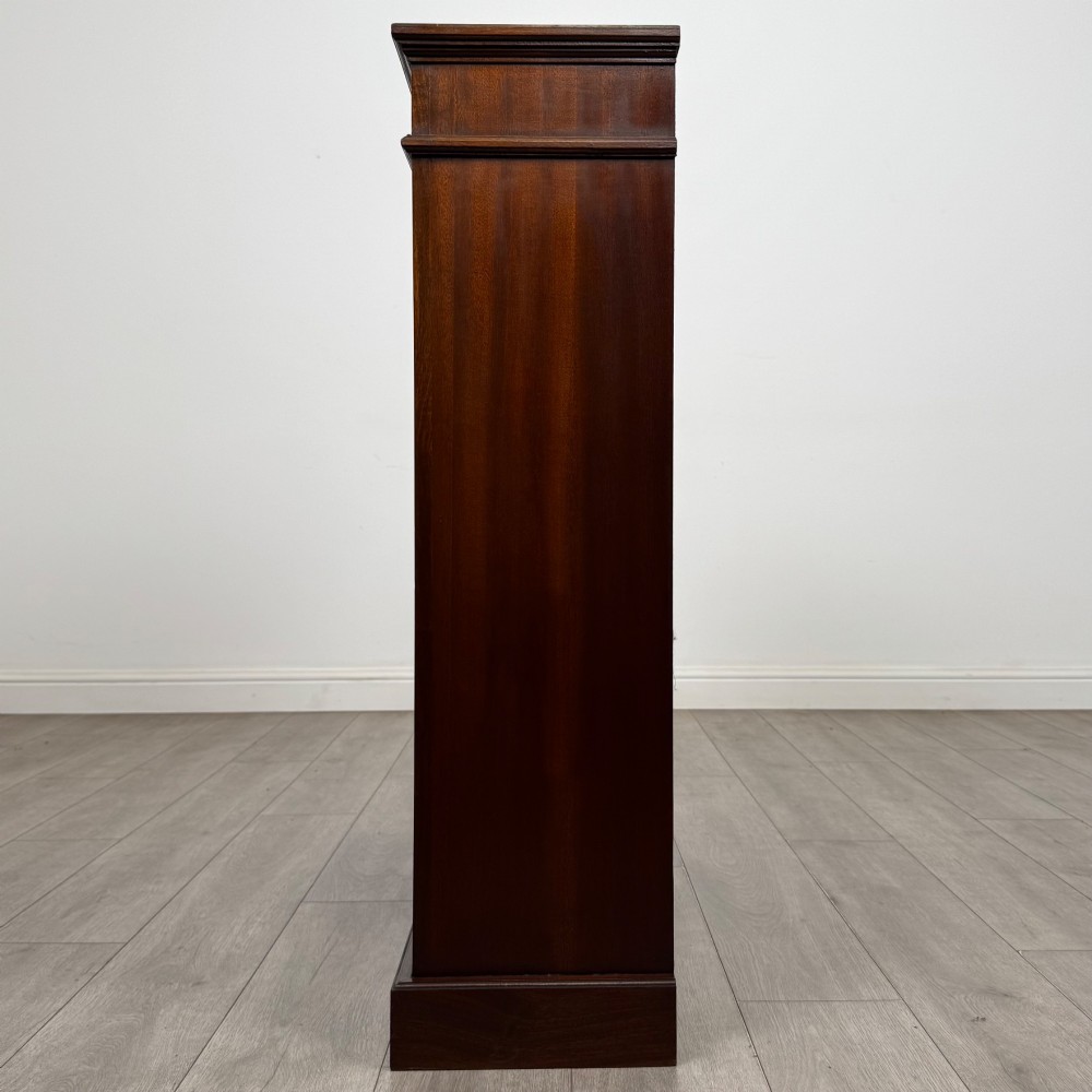 An early twentieth-century open mahogany bookcase featuring three wide horizontal shelves, a heavy moulded cornice, and a solid rectangular plinth base. View IV