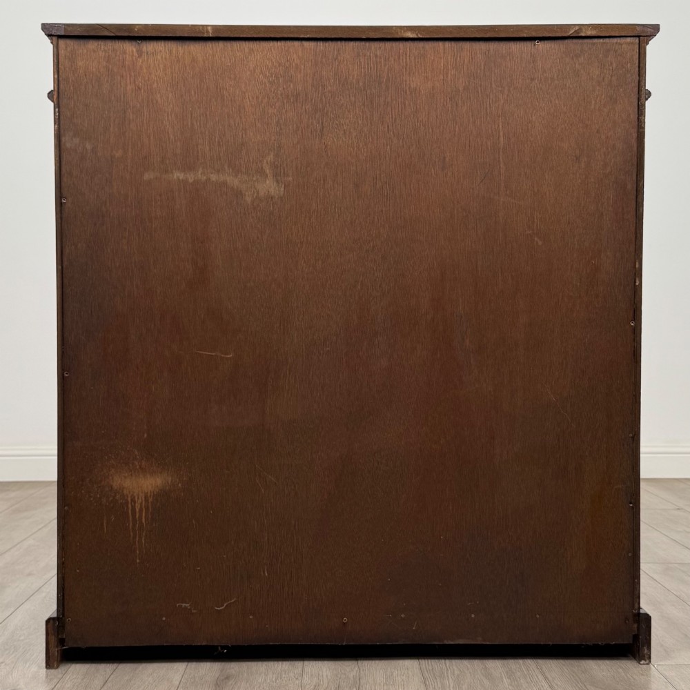 An early twentieth-century open mahogany bookcase featuring three wide horizontal shelves, a heavy moulded cornice, and a solid rectangular plinth base. View VI