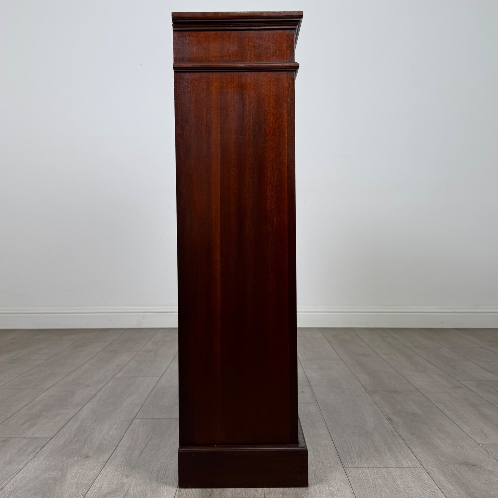 An early twentieth-century open mahogany bookcase featuring three wide horizontal shelves, a heavy moulded cornice, and a solid rectangular plinth base. View VIII