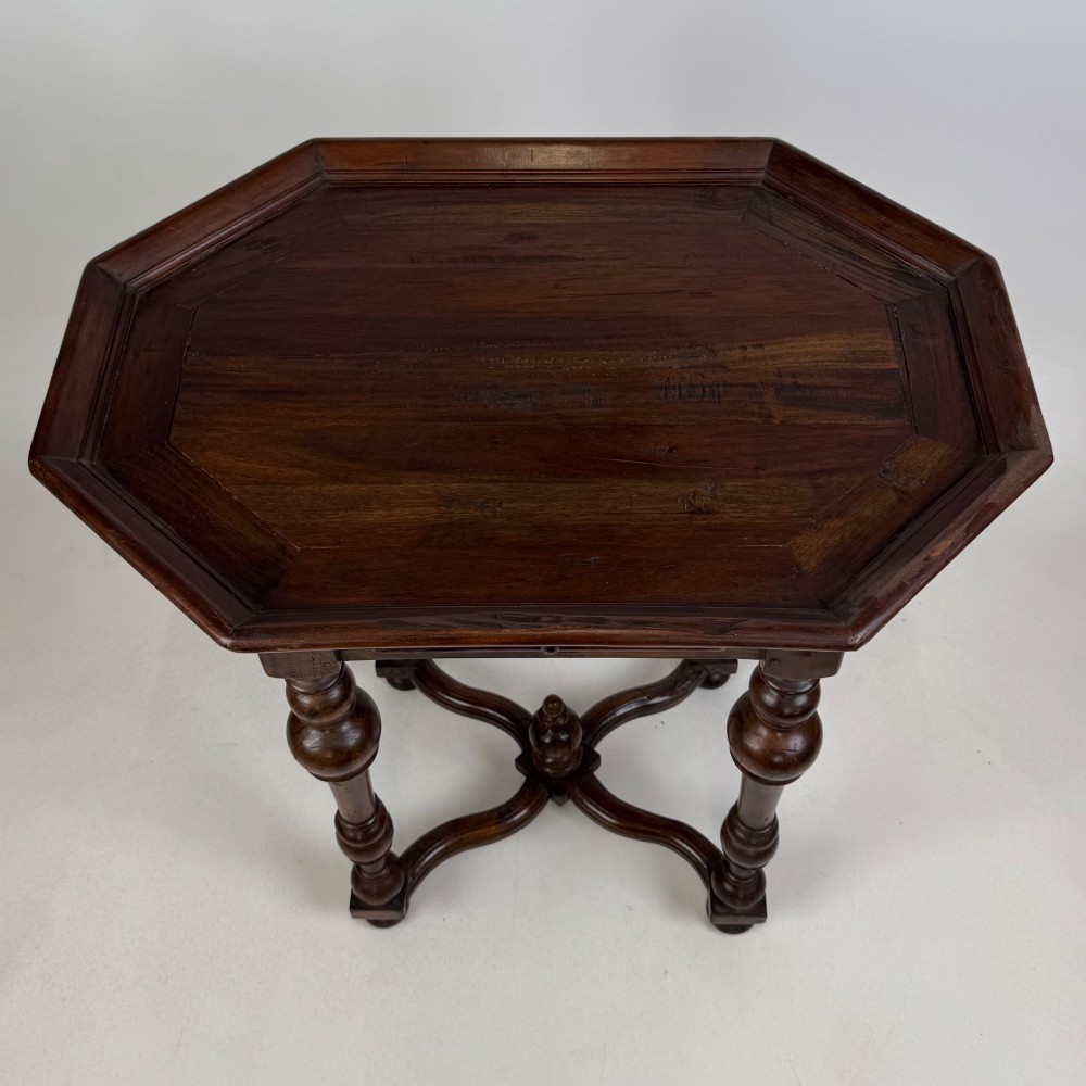 A dark brown hardwood octagonal side table with turned legs, a single drawer with a brass pull, and an arched cross-stretcher featuring a central finial. View IX