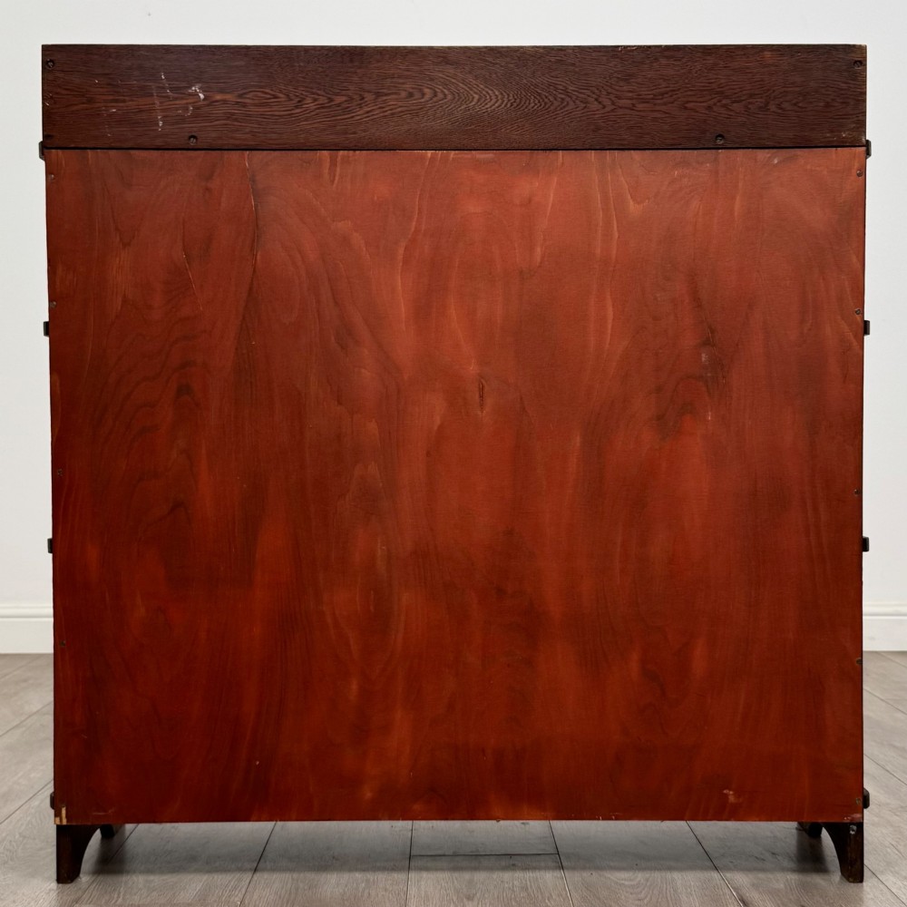 An early twentieth-century open golden oak bookcase featuring four wide wooden shelves and shaped side profile base. View VI