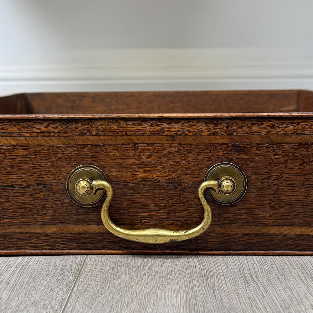 An 18th-century Georgian oak side table featuring three drawers with brass drop handles, an arched apron, and cabriole legs. View XI