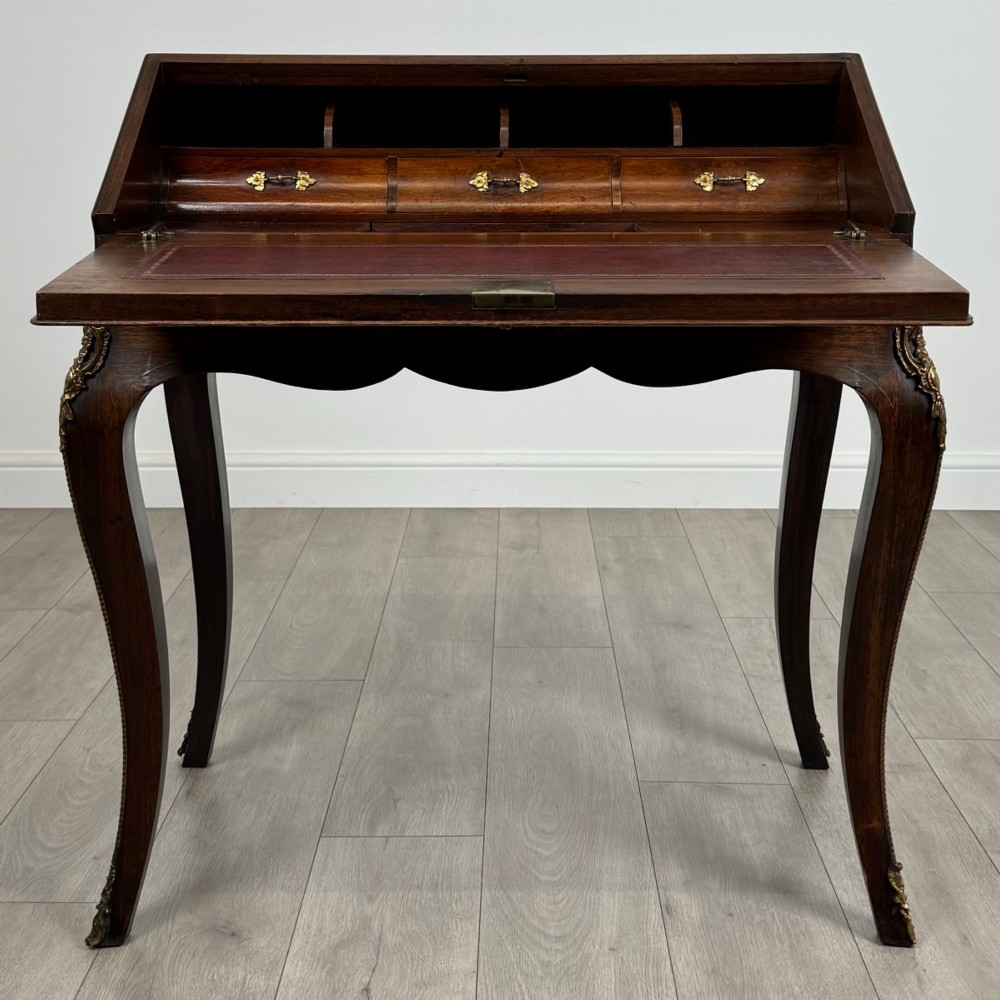 A 19th-century French rosewood bureau de dame with floral marquetry inlay on the hinged top and apron, raised on cabriole legs with gilt-bronze ormolu mounts. View II