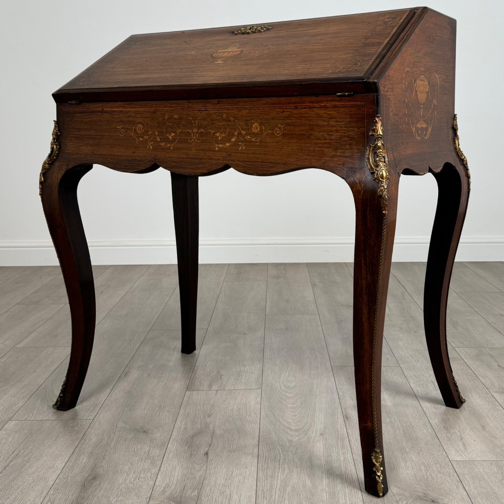 A 19th-century French rosewood bureau de dame with floral marquetry inlay on the hinged top and apron, raised on cabriole legs with gilt-bronze ormolu mounts. View III