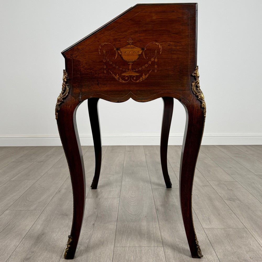 A 19th-century French rosewood bureau de dame with floral marquetry inlay on the hinged top and apron, raised on cabriole legs with gilt-bronze ormolu mounts. View IV