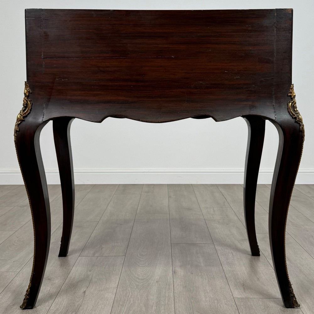 A 19th-century French rosewood bureau de dame with floral marquetry inlay on the hinged top and apron, raised on cabriole legs with gilt-bronze ormolu mounts. View VI