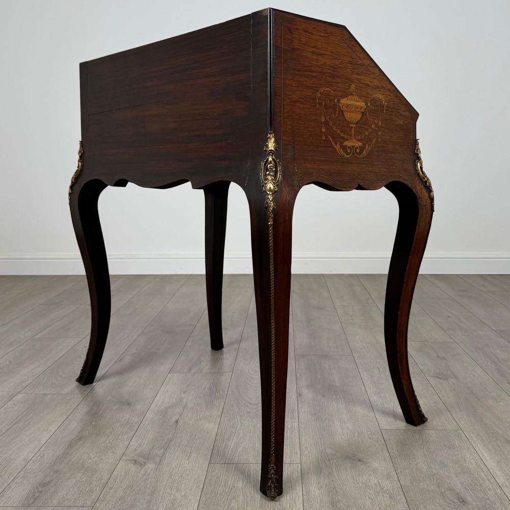 A 19th-century French rosewood bureau de dame with floral marquetry inlay on the hinged top and apron, raised on cabriole legs with gilt-bronze ormolu mounts. View VII