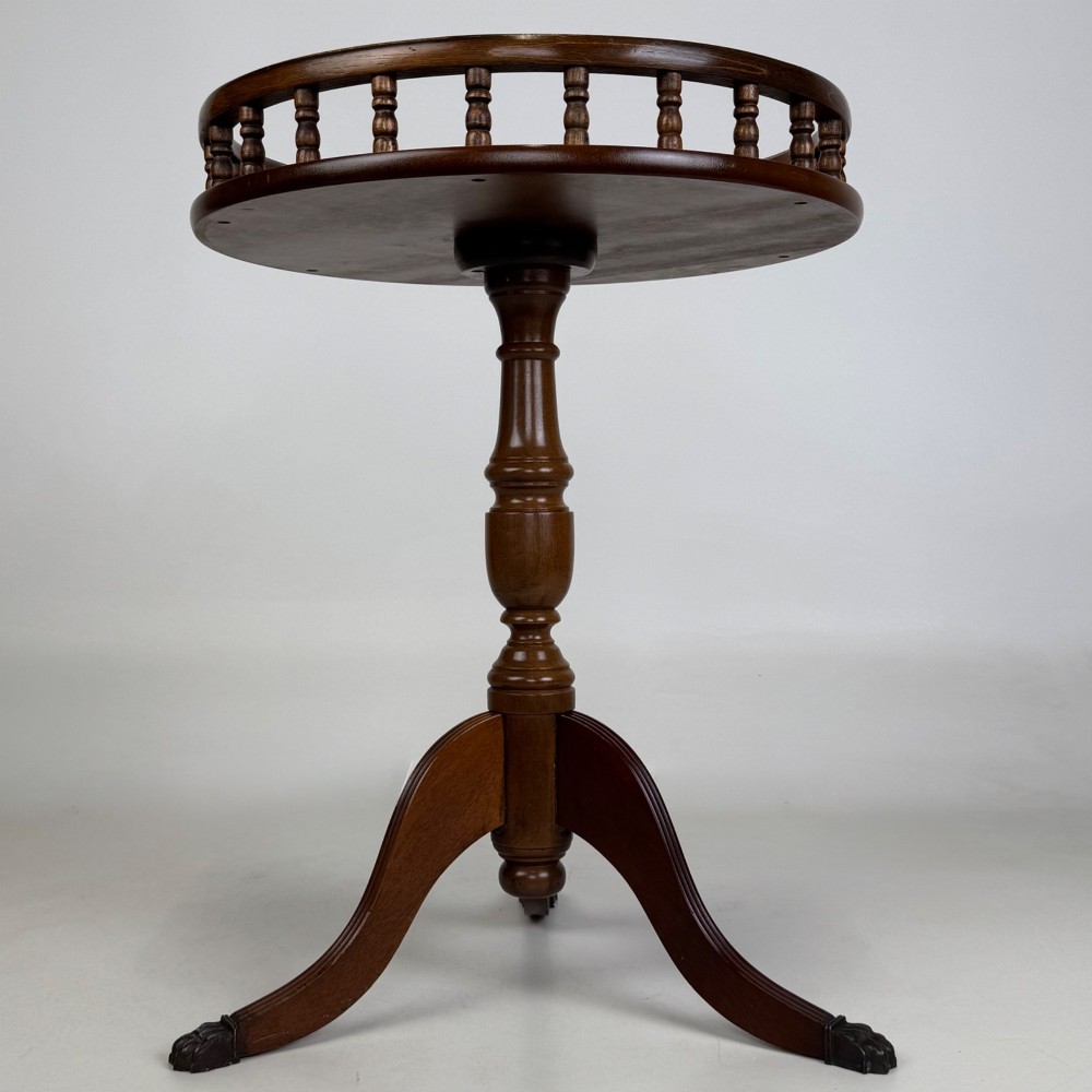 A dark brown beech side table featuring a spindle gallery rim around the circular top, a turned column support, and a tripod base with claw feet. View III
