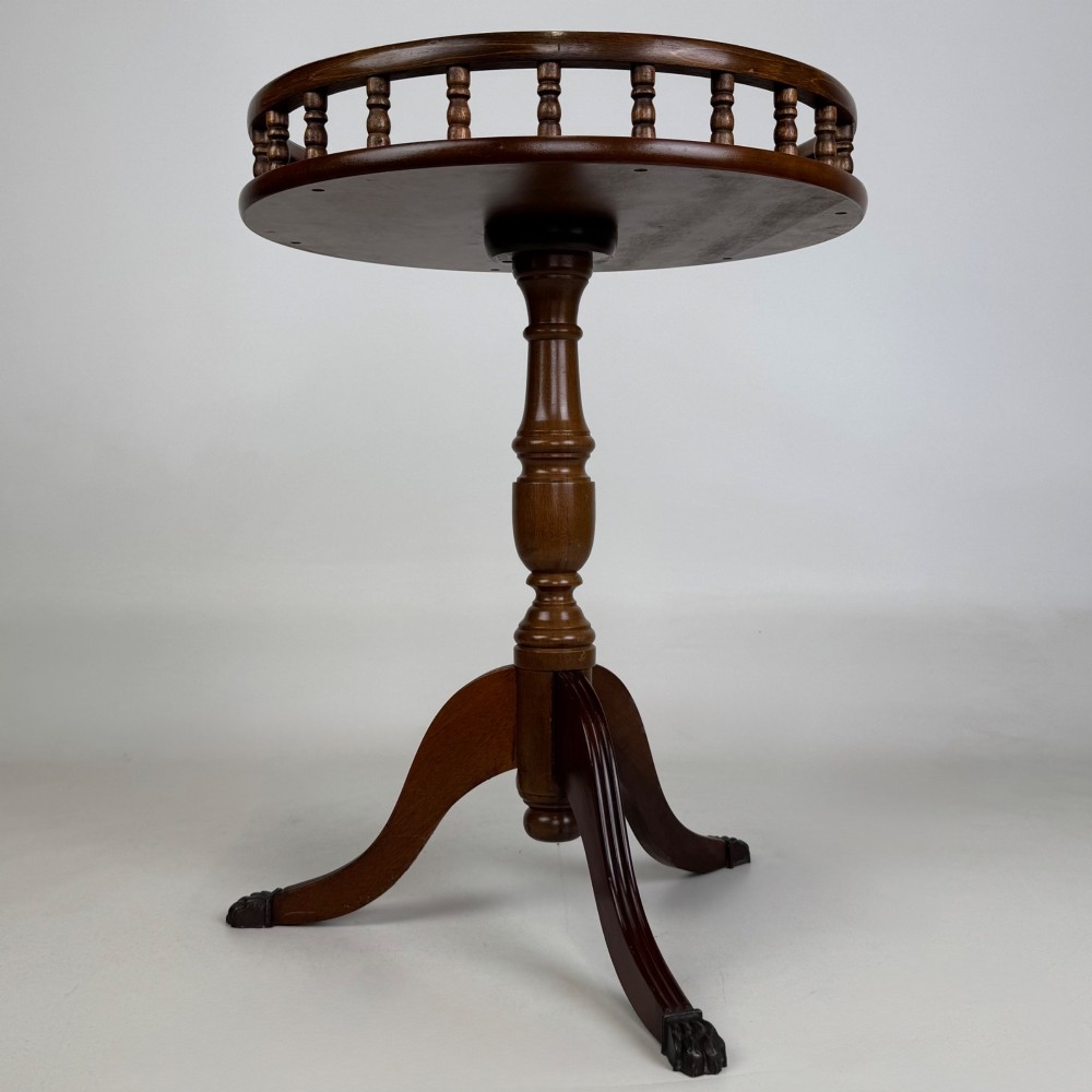 A dark brown beech side table featuring a spindle gallery rim around the circular top, a turned column support, and a tripod base with claw feet. View IV