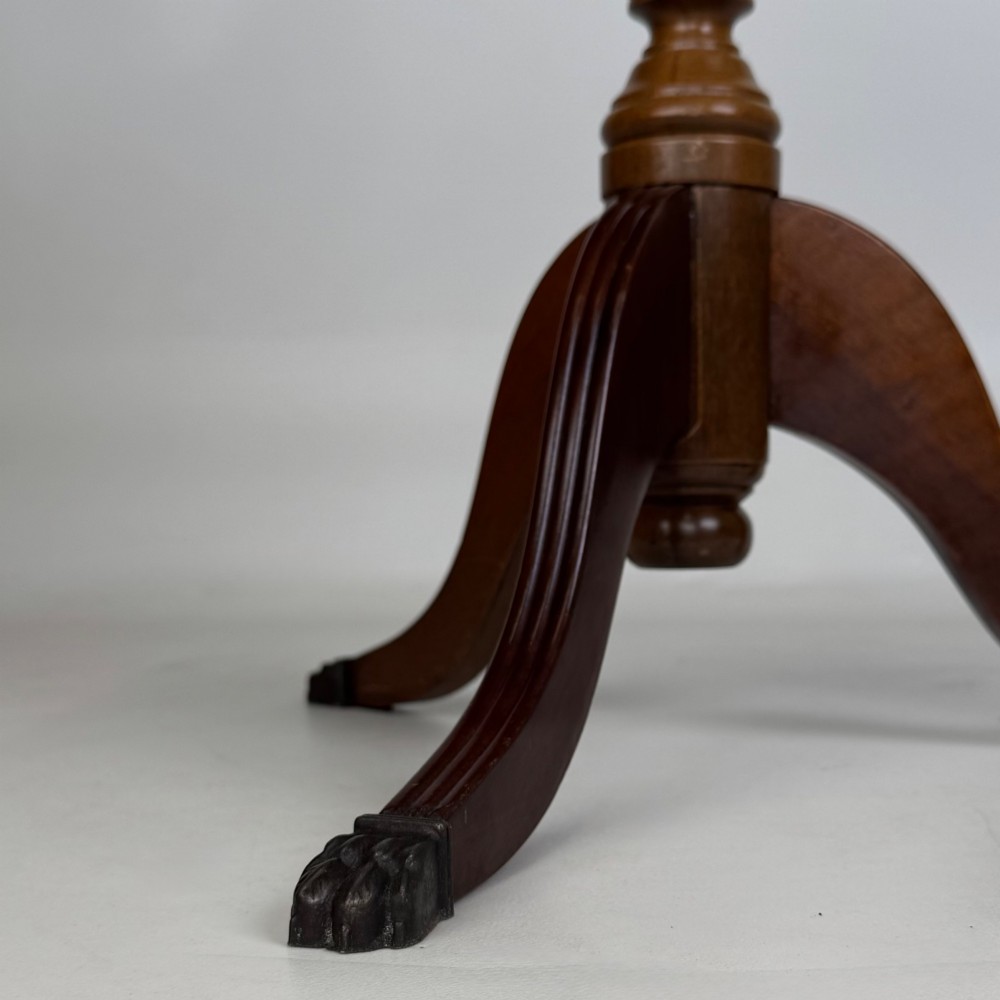 A dark brown beech side table featuring a spindle gallery rim around the circular top, a turned column support, and a tripod base with claw feet. View IX