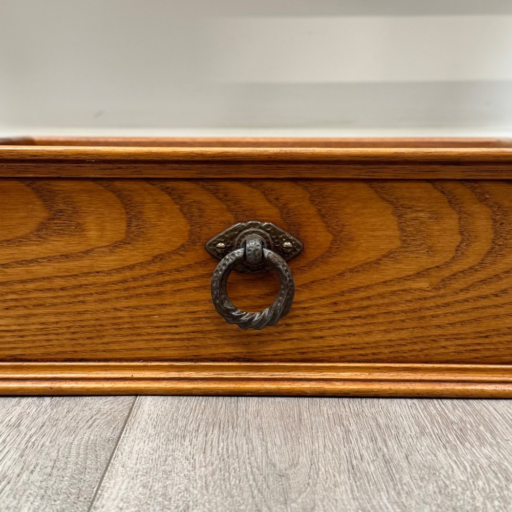 A 20th-century warm brown oak writing table featuring two frieze drawers with ring drop handles and four turned legs. View XI