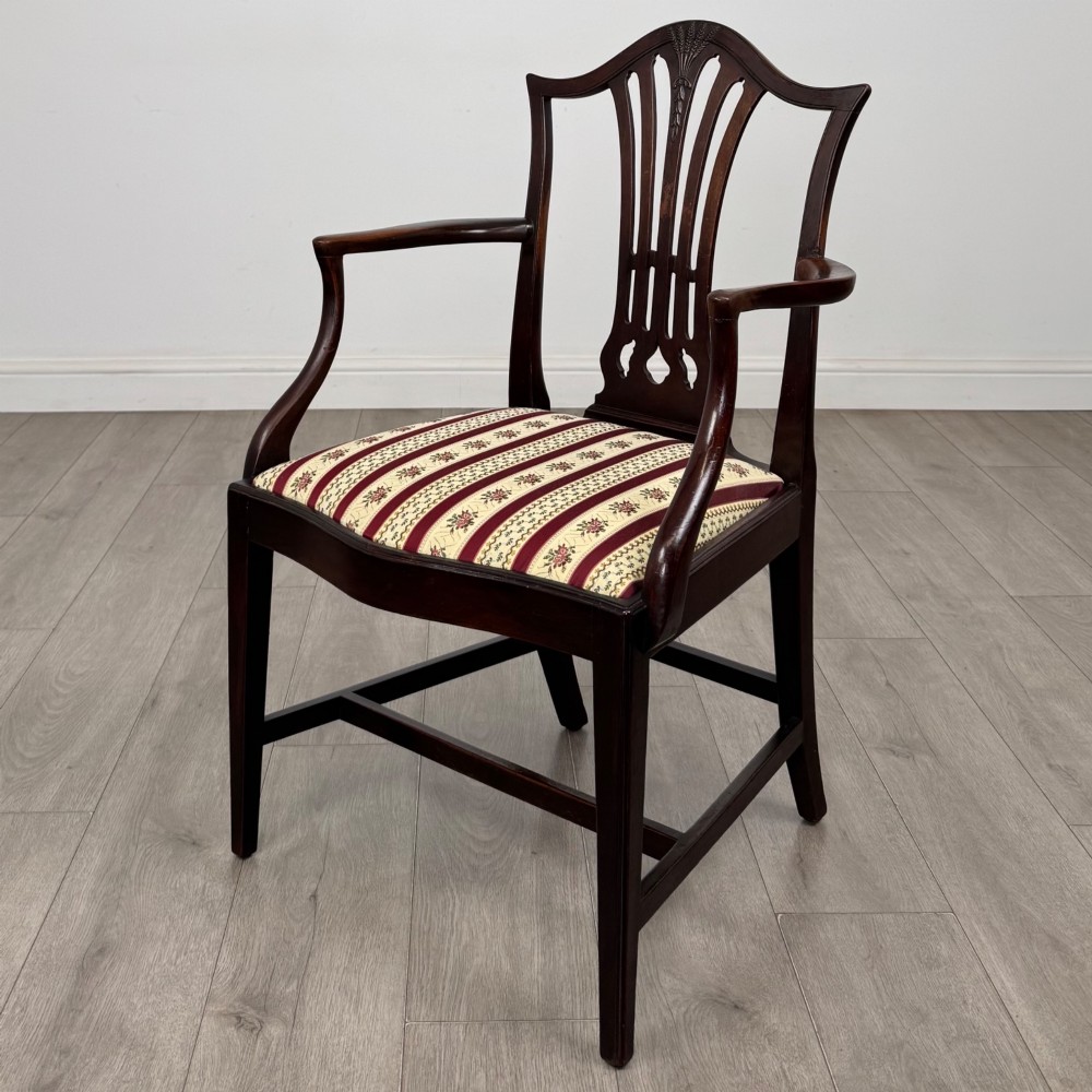 A set of eight dark mahogany shield back dining chairs, including two carvers and six side chairs, with striped red and cream upholstery. View II