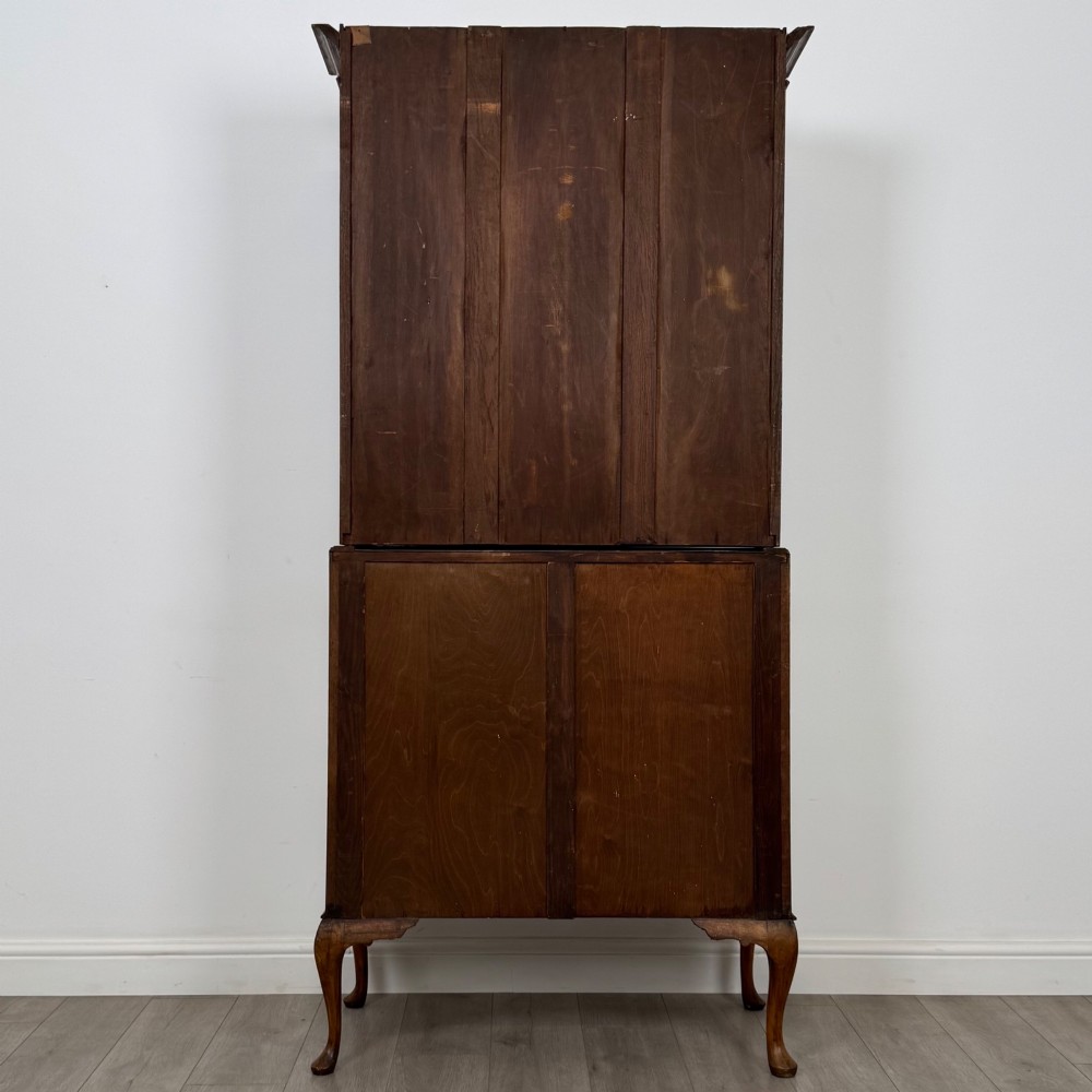 An Edwardian oak bureau bookcase with a two-door upper glazed display cabinet, a sloping drop-front desk, three wide drawers, and cabriole legs. View VII