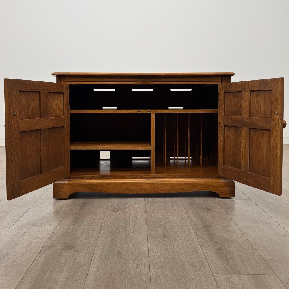 A two-door golden oak storage cupboard featuring geometric panelled doors, turned timber knobs, and a low plinth base. View II