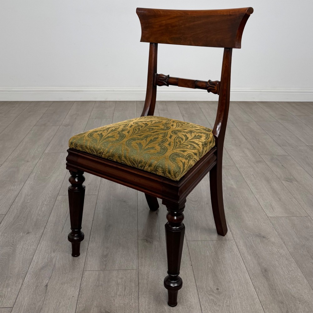 A set of six 19th-century William IV mahogany dining chairs featuring turned front legs, curved back rails, and green patterned fabric seats. View II