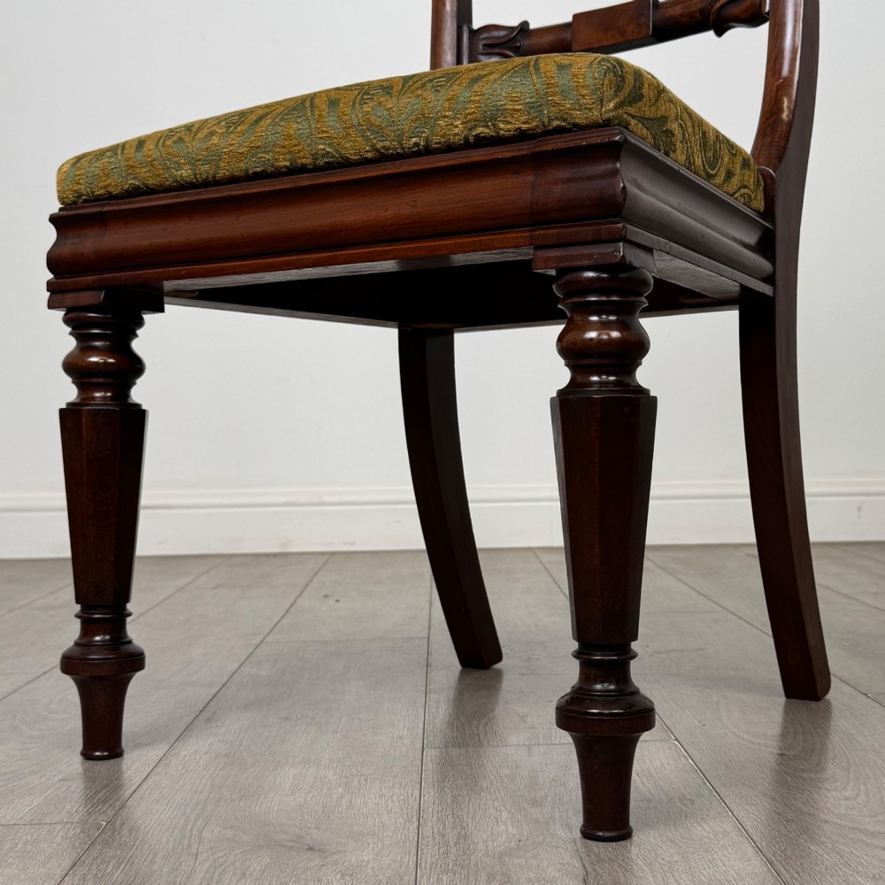 A set of six 19th-century William IV mahogany dining chairs featuring turned front legs, curved back rails, and green patterned fabric seats. View V