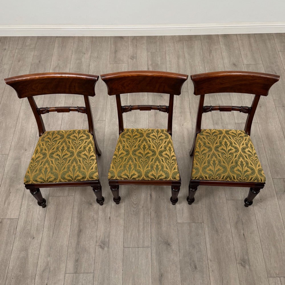 A set of six 19th-century William IV mahogany dining chairs featuring turned front legs, curved back rails, and green patterned fabric seats. View VIII