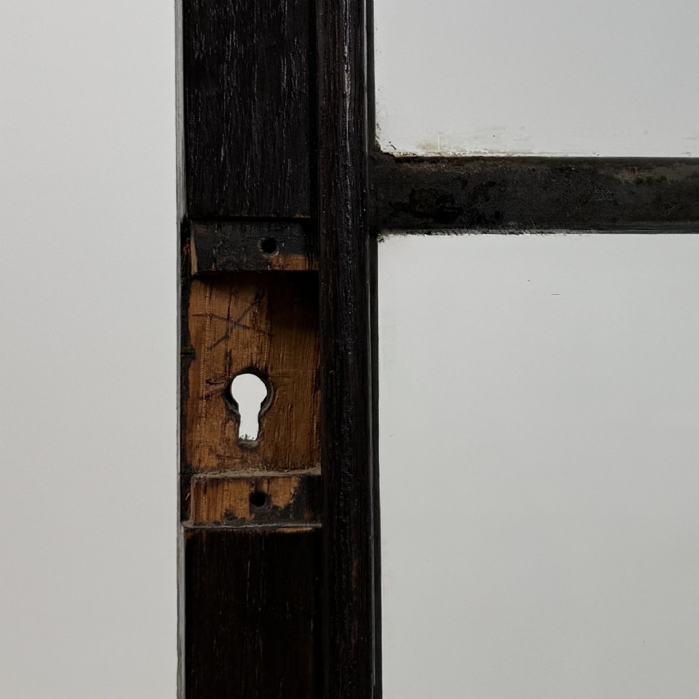 An ebonised oak bureau bookcase featuring an asymmetrical design with a glazed door cabinet, a slanted fall-front writing surface, open shelving, and a heart cutout crest. View XIII