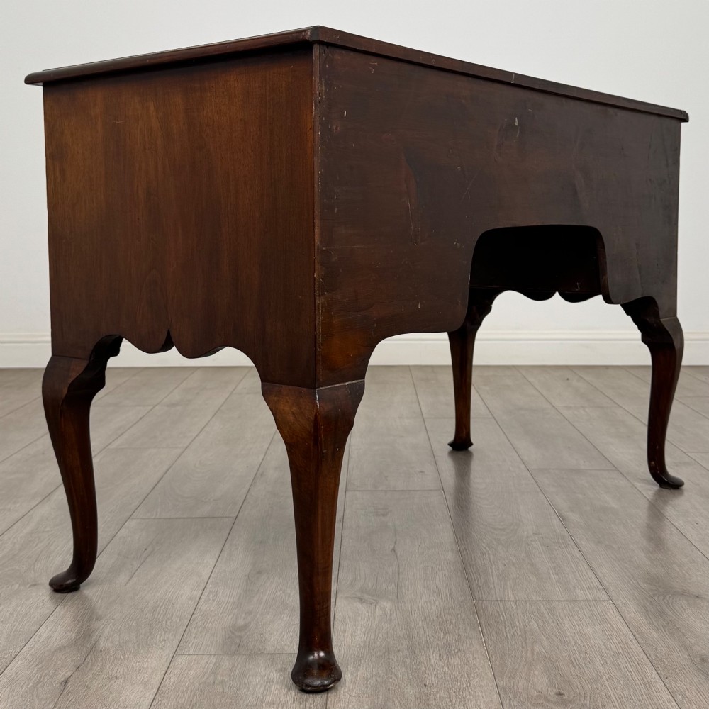 A 19th-century Victorian writing table crafted from burr walnut with five drawer fronts, ornate brass drop handles, a shaped central kneehole, and cabriole legs. View IV