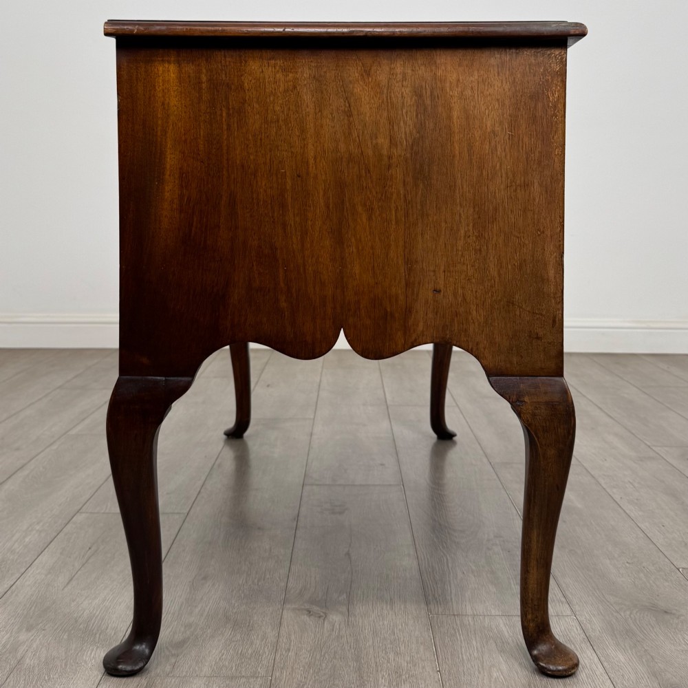 A 19th-century Victorian writing table crafted from burr walnut with five drawer fronts, ornate brass drop handles, a shaped central kneehole, and cabriole legs. View VII
