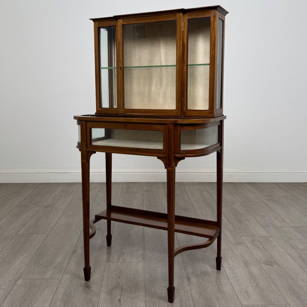 An Edwardian mahogany glazed display cabinet featuring tapered legs, line inlay detailing, glass shelves, and a lower undertier shelf. View III