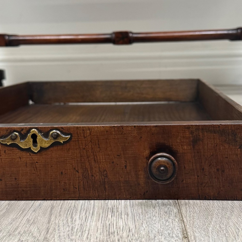 A 19th-century Regency style yew wood side table featuring drop-leaf ends, twin drawers with brass escutcheons and round knobs, turned twin-stem supports, a stretcher, and brass castors. View XIII