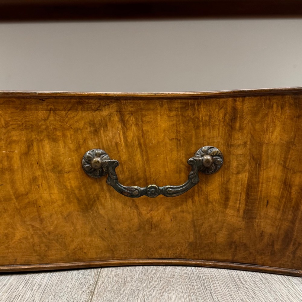 An Edwardian burr walnut sideboard featuring three central drawers flanked by two cupboard doors, set on carved cabriole legs. View XII