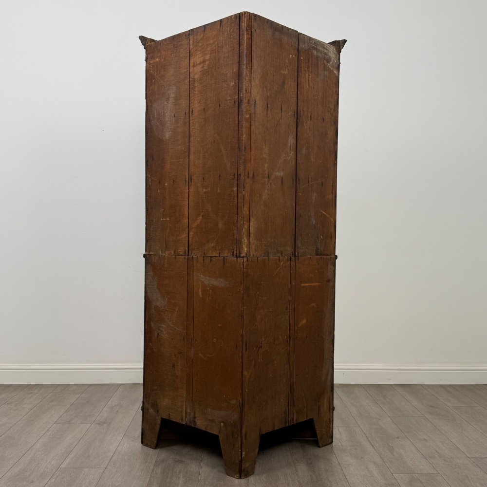 An eighteenth century Georgian dark oak standing corner cabinet featuring upper geometric astragal glazed doors and lower panelled cupboard doors. View III