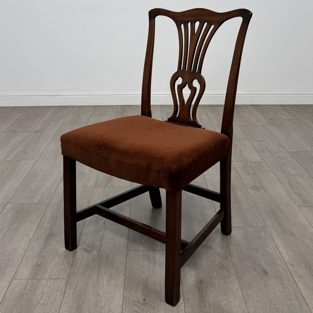 A set of six dark wood Georgian style dining chairs featuring pierced splat backs and dark brown velvet upholstered seats. View II
