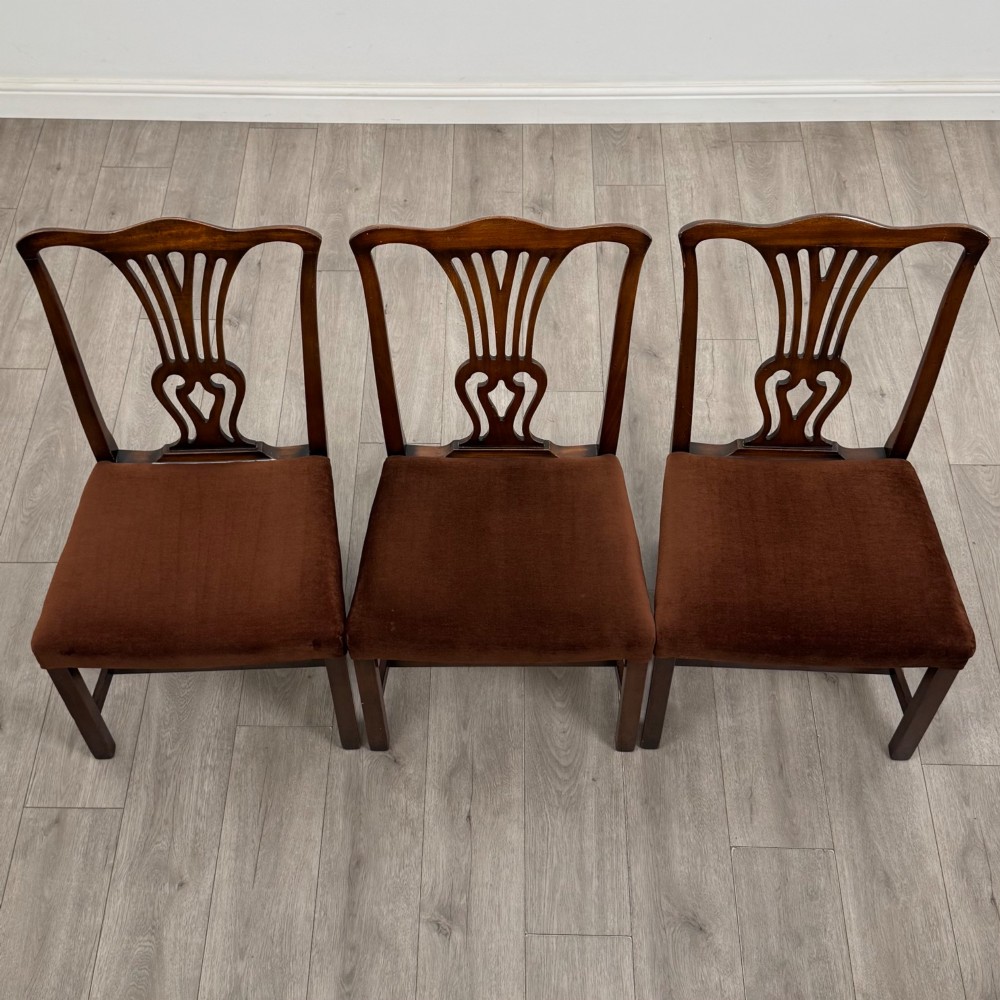 A set of six dark wood Georgian style dining chairs featuring pierced splat backs and dark brown velvet upholstered seats. View VII