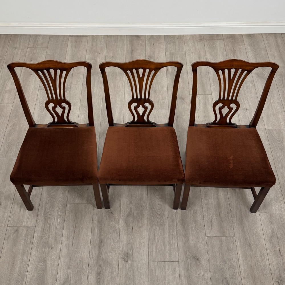A set of six dark wood Georgian style dining chairs featuring pierced splat backs and dark brown velvet upholstered seats. View VIII